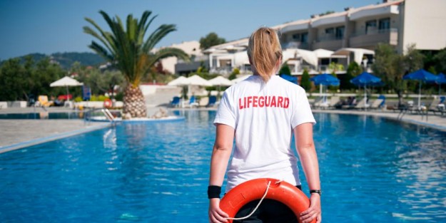 Lifeguard Female lifeguard on duty at a swimming pool