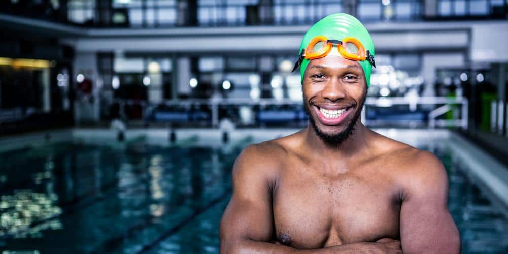 Fit swimmer standing with arms crossed in swimming pool Fit swimmer standing with arms crossed in swimming pool